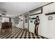 This bonus room features checkered flooring, a bar, and unique decorative elements at 8103 E Southern Ave # 69, Mesa, AZ 85209