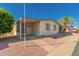 Charming single-story home featuring a covered entrance, carport and low-maintenance rock landscaping at 8103 E Southern Ave # 69, Mesa, AZ 85209