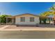 Charming single-story home with low-maintenance landscaping, carport, and mature palm trees at 8103 E Southern Ave # 69, Mesa, AZ 85209