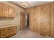 Kitchen area with wood paneling and basic cabinet storage space at 8103 E Southern Ave # 69, Mesa, AZ 85209