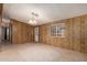 Inviting living room with paneled walls, large window, and doorway to a connected room at 8103 E Southern Ave # 69, Mesa, AZ 85209