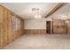 Open-concept living room featuring wood paneling, neutral carpet and a classic chandelier at 8103 E Southern Ave # 69, Mesa, AZ 85209