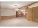 Spacious living room featuring wood paneling, neutral carpet and plenty of space for entertaining at 8103 E Southern Ave # 69, Mesa, AZ 85209