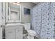 Clean bathroom features a modern vanity, updated fixtures, and neutral shower curtain at 8415 W Coolidge St, Phoenix, AZ 85037