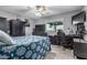 This bedroom is decorated with gray paint, wood-look tile floors, and a blue floral comforter at 8415 W Coolidge St, Phoenix, AZ 85037