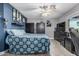 This bedroom has wood-look tile flooring, blue accent wall, gray walls, and a ceiling fan at 8415 W Coolidge St, Phoenix, AZ 85037