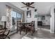 Cozy dining area features wood table, gray walls, wood-look tile floor, updated light fixture, and natural light at 8415 W Coolidge St, Phoenix, AZ 85037