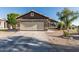 Charming single-story home featuring a neutral color, desert landscaping, and a two-car garage in a residential neighborhood at 8415 W Coolidge St, Phoenix, AZ 85037