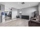 Open living space with tile flooring, a comfortable couch and a glimpse into the adjoining spaces at 8415 W Coolidge St, Phoenix, AZ 85037