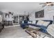 Open-concept living room featuring tile flooring, comfortable seating, modern decor, and plenty of natural light at 8415 W Coolidge St, Phoenix, AZ 85037