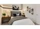 Eclectic bedroom featuring skateboards as wall art, stylish lamps, and decor at 9621 W Monterey Way, Phoenix, AZ 85037