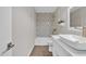 Updated bathroom with decorative tile surround, quartz counters and modern fixtures at 1051 S Dobson Rd # 67, Mesa, AZ 85202