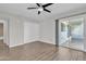 The airy bedroom features a sliding door to the patio, closet, and wood-look floors at 1051 S Dobson Rd # 67, Mesa, AZ 85202