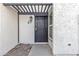 Inviting entryway with pergola, security door, and textured exterior at 1051 S Dobson Rd # 67, Mesa, AZ 85202