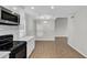 Updated kitchen with stainless steel appliances, quartz counters, and adjoining dining area with a modern light fixture at 1051 S Dobson Rd # 67, Mesa, AZ 85202