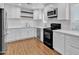 Modern kitchen with white cabinetry, quartz countertops, subway tile backsplash, and stainless steel appliances at 1051 S Dobson Rd # 67, Mesa, AZ 85202