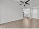 Bright living room featuring wood-look tile flooring, neutral walls, and a modern ceiling fan at 1051 S Dobson Rd # 67, Mesa, AZ 85202