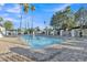 Inviting community pool surrounded by a brick patio and plenty of seating with palm trees providing shade at 1051 S Dobson Rd # 67, Mesa, AZ 85202