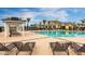 Resort-style community pool with lounge chairs, gazebo, and palm trees, perfect for relaxation and recreation at 10538 E Naranja Ave, Mesa, AZ 85209
