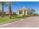 Community entrance to development with lush landscaping and palm trees at 10538 E Naranja Ave, Mesa, AZ 85209