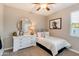 Bright bedroom showcasing a twin bed, dresser, and decorative mirror, creating a cozy and inviting space at 10556 W Bloch Rd, Tolleson, AZ 85353