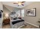 Stylish bedroom featuring a cozy queen bed, unique wall decor, and complementary furnishings for a modern aesthetic at 10556 W Bloch Rd, Tolleson, AZ 85353