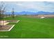 Beautiful community park featuring lush green lawns, walking paths, and mountain views at 10556 W Bloch Rd, Tolleson, AZ 85353