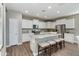 Bright, modern kitchen with a large island, stainless steel appliances, and sleek white cabinetry, perfect for cooking and entertaining at 10556 W Bloch Rd, Tolleson, AZ 85353