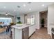 Open concept kitchen and dining area with stainless steel appliances, a granite island, and stylish decor at 10556 W Bloch Rd, Tolleson, AZ 85353