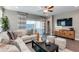Modern living room with stylish accents, comfortable seating, and a sliding glass door to the backyard at 10556 W Bloch Rd, Tolleson, AZ 85353
