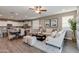 Spacious living area with a dining table and modern kitchen featuring granite countertops and stainless steel appliances at 10556 W Bloch Rd, Tolleson, AZ 85353