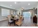Bright living room with tile flooring, dining table, and large windows offering plenty of natural light at 10556 W Bloch Rd, Tolleson, AZ 85353
