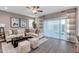 Cozy living room with stylish decor, comfortable seating, and sliding glass doors leading to outdoor area at 10556 W Bloch Rd, Tolleson, AZ 85353