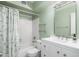 Bathroom featuring white vanity and shower over tub with neutral paint and modern lighting at 10613 S 41St Pl, Phoenix, AZ 85044