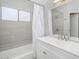 This is a bathroom with white vanity and shower over tub with neutral tile at 10613 S 41St Pl, Phoenix, AZ 85044