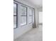 Bright hallway featuring neutral tile flooring, white walls, and natural light pouring through the large windows at 10613 S 41St Pl, Phoenix, AZ 85044