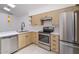 This kitchen features stainless steel appliances, modern cabinets, and gorgeous countertops at 10613 S 41St Pl, Phoenix, AZ 85044