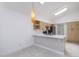 Bright kitchen with modern stainless steel appliances, sleek white countertops, and light wood cabinetry at 10613 S 41St Pl, Phoenix, AZ 85044