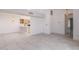 Open-concept living area with tile flooring, white walls, and a view into the kitchen and dining space at 10613 S 41St Pl, Phoenix, AZ 85044