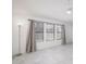 Open living space featuring tile floors, neutral walls, large windows, and modern lighting fixtures at 10613 S 41St Pl, Phoenix, AZ 85044