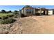 New home under construction with a partial roof, wood framework and dirt yard at 11410 E Utah Ave, Mesa, AZ 85212