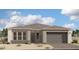 Charming single-story home with a gray stucco exterior, gray tiled roof, and a two-car garage at 11410 E Utah Ave, Mesa, AZ 85212