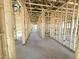 Unfinished interior showcasing the bare framework and concrete flooring in a new construction home at 11410 E Utah Ave, Mesa, AZ 85212