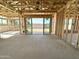 Unfinished living room space with wood framework and sliding glass doors leading to the backyard at 11410 E Utah Ave, Mesa, AZ 85212