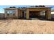 Unfinished house construction showing the frame of the home and garage with a dirt-filled yard at 11410 E Utah Ave, Mesa, AZ 85212