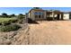 A new construction house showing the framing and construction of the garage, walls, and the yard filled with dirt at 11410 E Utah Ave, Mesa, AZ 85212