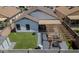 A high angle view shows a backyard with synthetic grass, pergola with outdoor furniture, and a storage shed at 11601 W Bloomfield Rd, El Mirage, AZ 85335