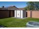 Backyard includes a storage shed in a low maintenance space with turf grass at 11601 W Bloomfield Rd, El Mirage, AZ 85335