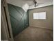 Bedroom with decorative green accent wall, ceiling fan, and a window that brings in natural light at 11601 W Bloomfield Rd, El Mirage, AZ 85335
