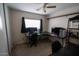 This bedroom is equipped with multiple monitors and a ceiling fan at 11601 W Bloomfield Rd, El Mirage, AZ 85335